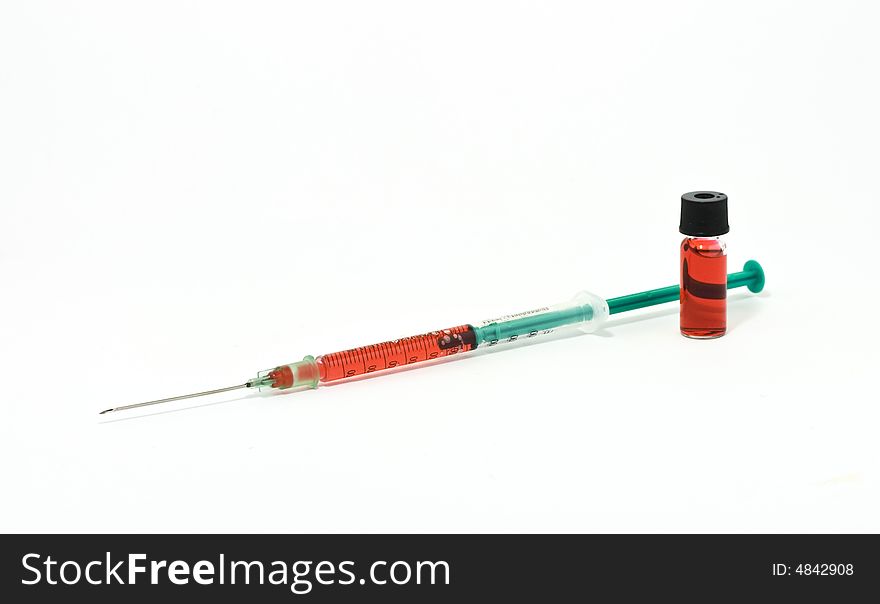 Syringe and vial on white