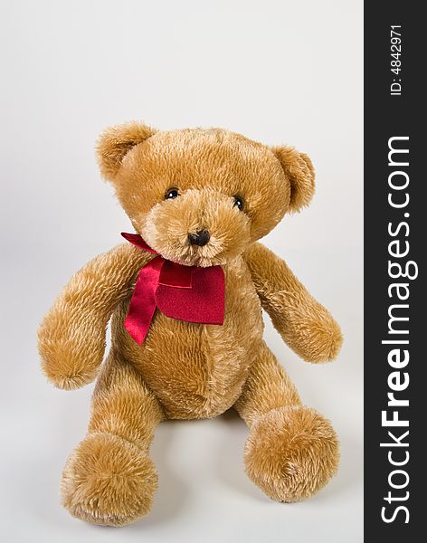 Classic teddy bear with red heart isolated on white background