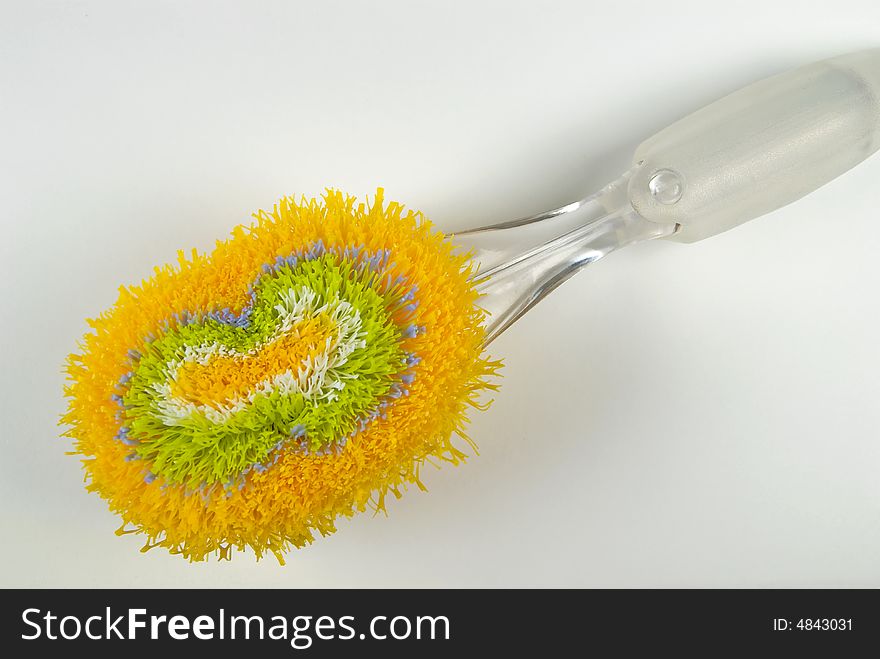 Colorful brush for dishes - closeup on white background