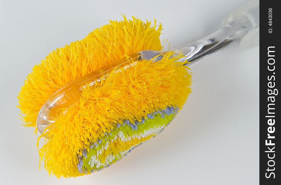 Colorful brush for dishes - closeup on white background