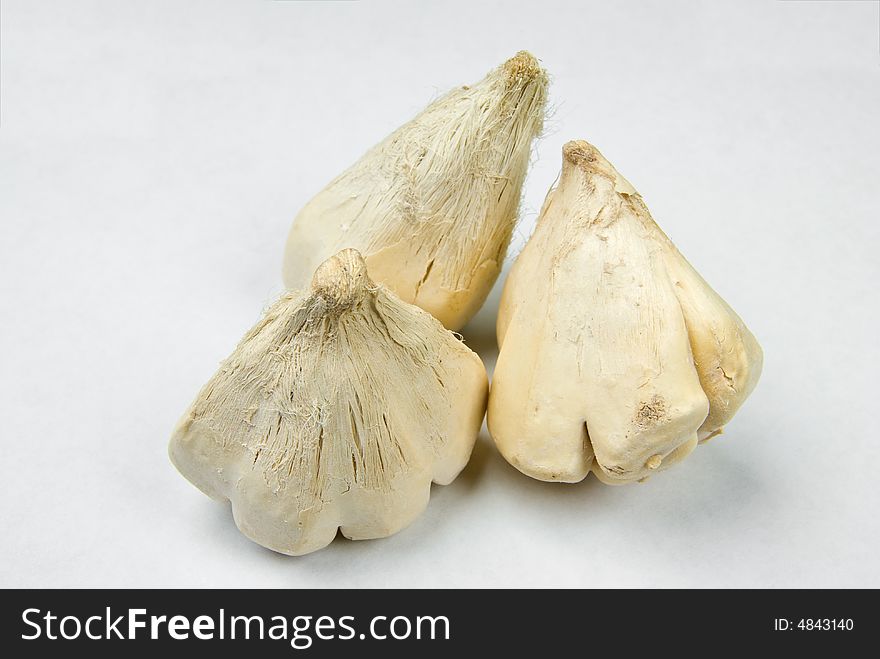 Dried garlic bulbs over white background