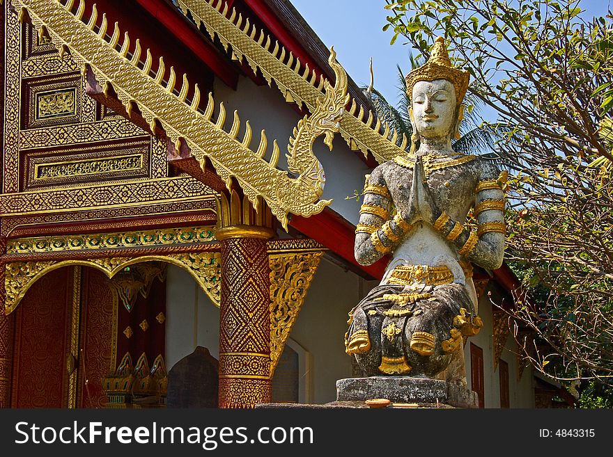 Thailand, temple in Chiang Mai. Statue of a sitting deity in old temple in Chiang Mai.