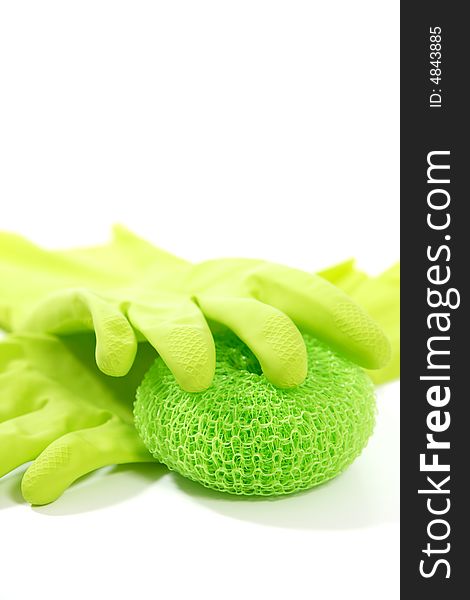 Green rubber gloves and a scrub pad close up in the studio. Green rubber gloves and a scrub pad close up in the studio