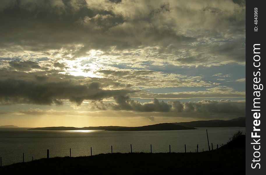 Scottish sunset during travel on the isle of Skye. Sun circle in the middle of the atlantic ocean