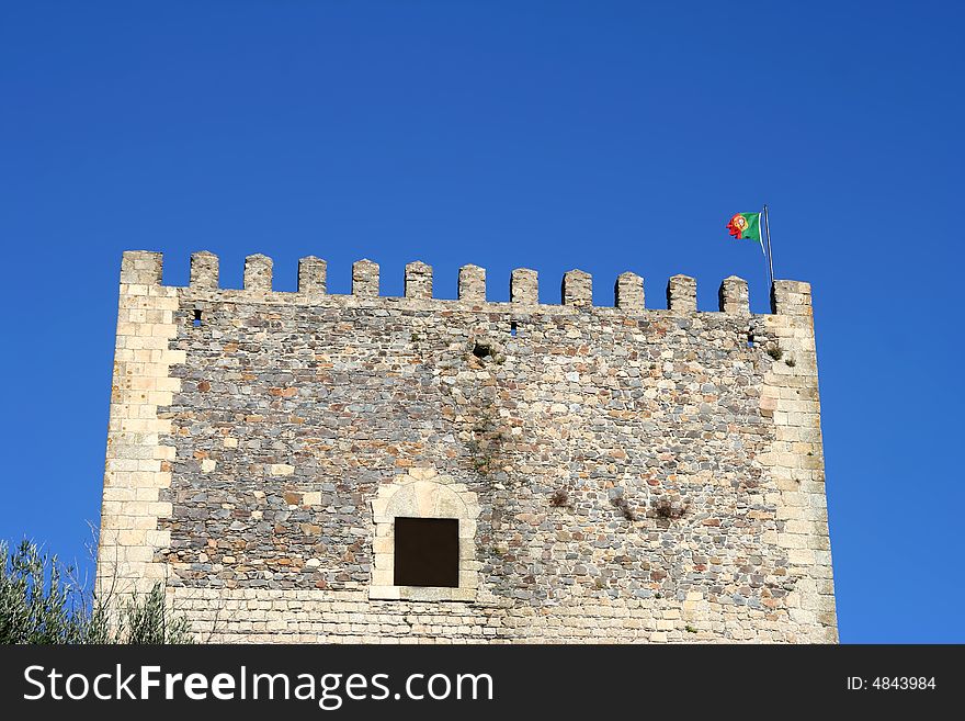 Tower of Castle in Alentejo, with the Portugal Flag. Tower of Castle in Alentejo, with the Portugal Flag