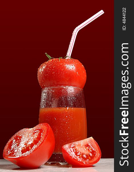 Tomatoes and tomato juice isolated on dark red background. Tomatoes and tomato juice isolated on dark red background