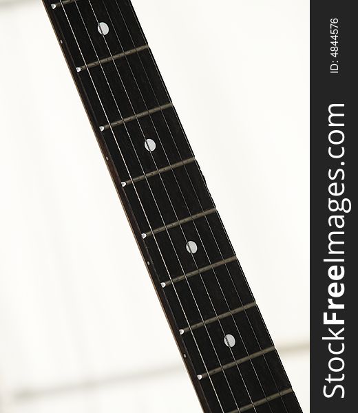 Finger board of an electric guitar isolated in white