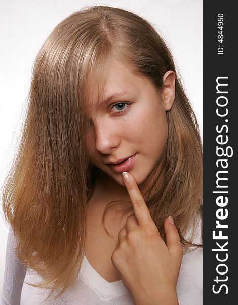 Portrait of a young blond girl with finger at her lips. Portrait of a young blond girl with finger at her lips