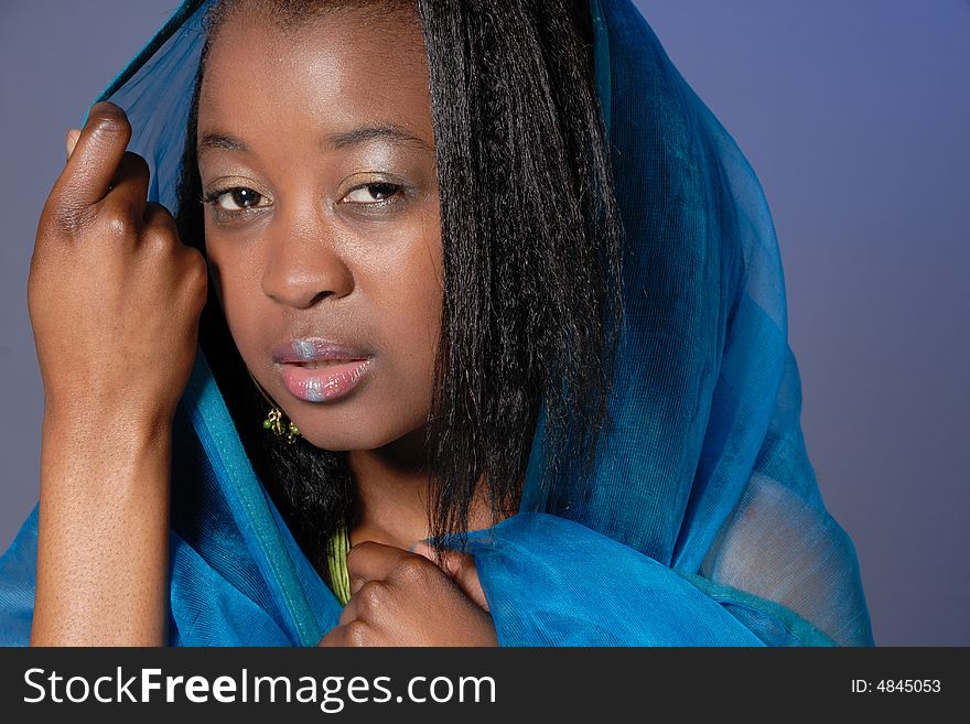 Portrait of attractive young African girl in teal wrap