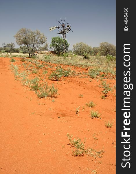 Destroyed Windmill with red sand and shrubby plants. Tanami road, Northern Territory. Australia. Destroyed Windmill with red sand and shrubby plants. Tanami road, Northern Territory. Australia