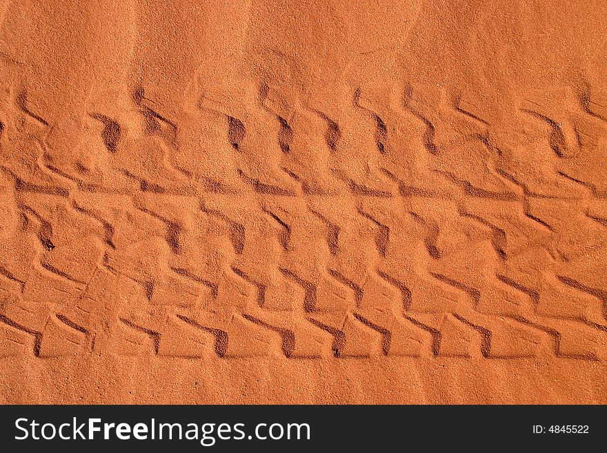 Car tracks in sand