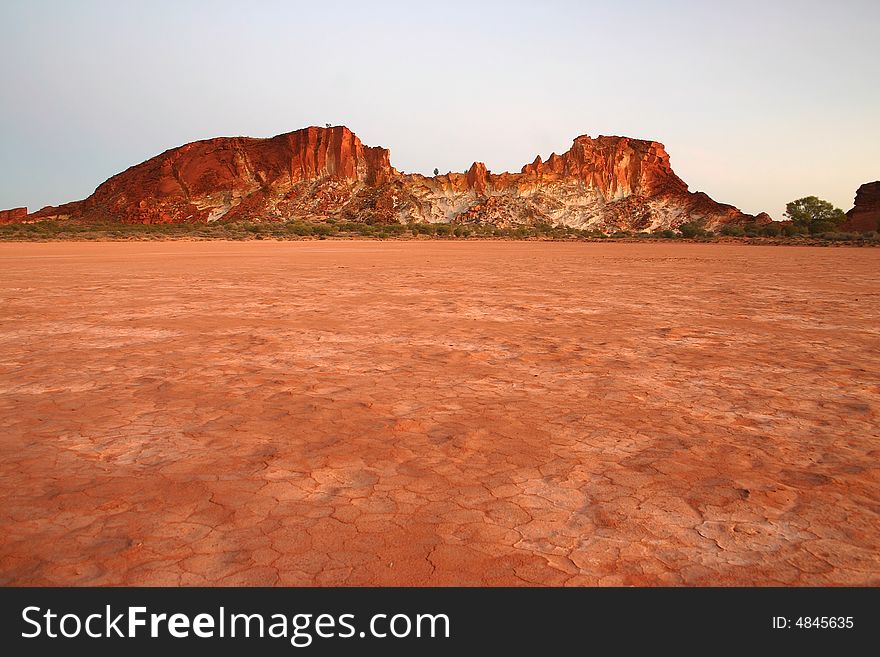 Parched red grounds with famous rocky range. Rainbow valley, Southern Northern Territory, Australia. Parched red grounds with famous rocky range. Rainbow valley, Southern Northern Territory, Australia