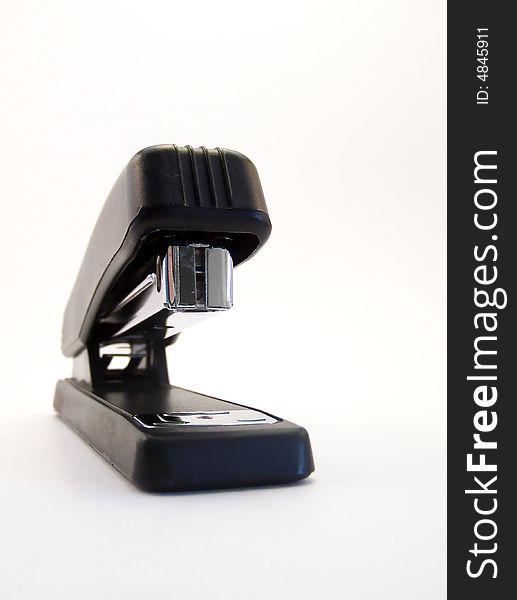 Image of a black stapler on white background.  Vertical orientation. Image of a black stapler on white background.  Vertical orientation.