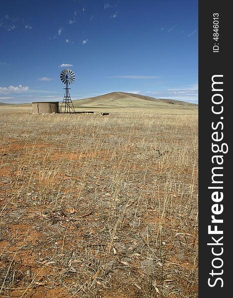 Windmill standing still in the middle of a cultivated field. South Australia