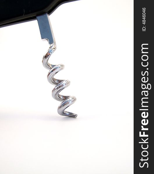 Detailed image of a metal corkscrew with black handle, entering the frame from the top.  Vertical orientation. Detailed image of a metal corkscrew with black handle, entering the frame from the top.  Vertical orientation.