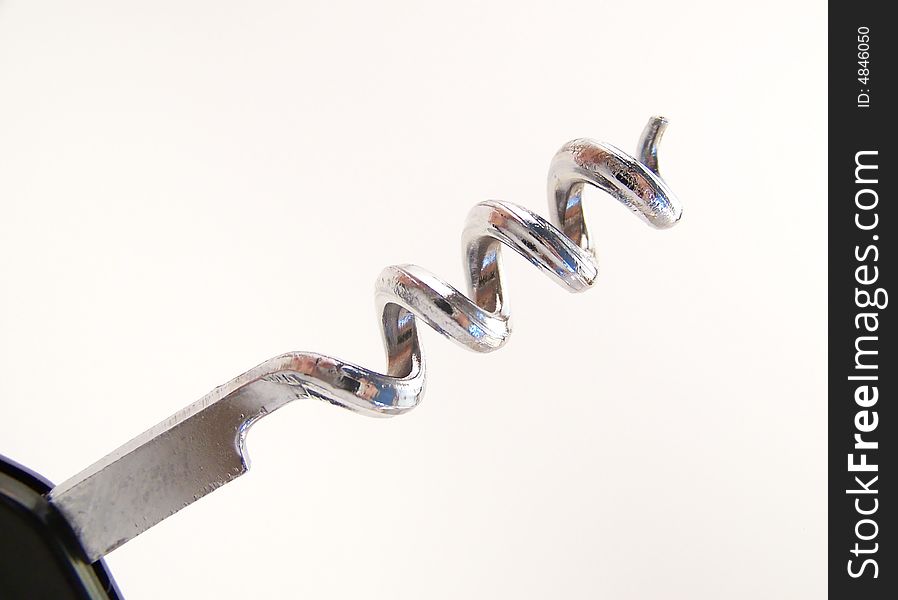 Detailed image of a metal corkscrew with black handle.  Horizontal orientation. Detailed image of a metal corkscrew with black handle.  Horizontal orientation.