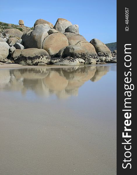 Wet sand with famous stones of Wilsons Promontory national park. Victoria. Australia