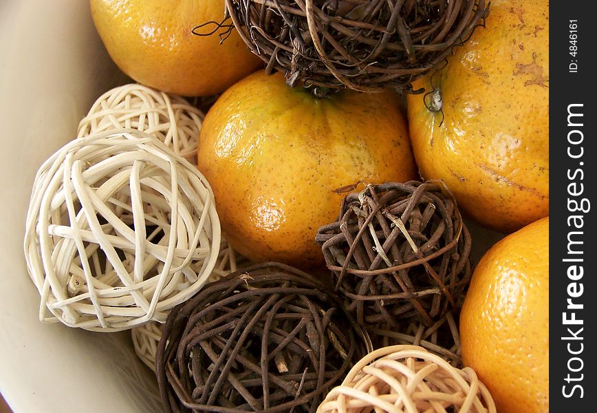 Image of honey tangerines and vine decorations.  Horizontal orientation.