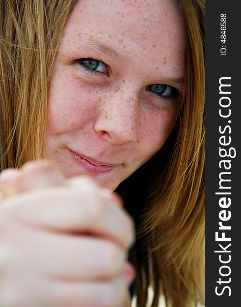 A teenager with a cheeky grin arm wrestling. A teenager with a cheeky grin arm wrestling