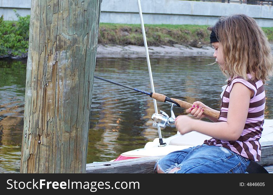 Jazzy sits on dock fishing in the St. Lucie River, Florida. Jazzy sits on dock fishing in the St. Lucie River, Florida