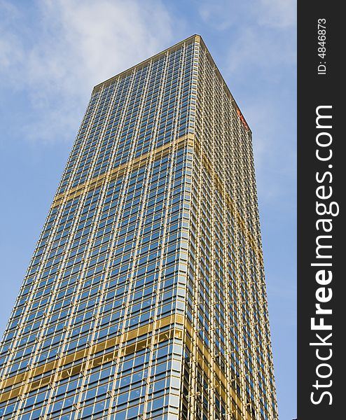 Large skyscraper office builiding with blue sky behind. Large skyscraper office builiding with blue sky behind