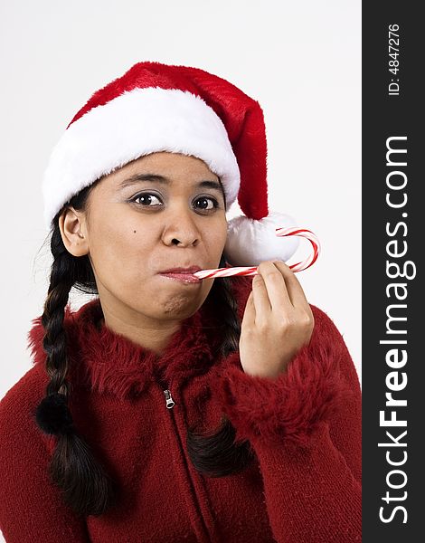 Vertical image of girl in a santa hat and candy cane. Vertical image of girl in a santa hat and candy cane