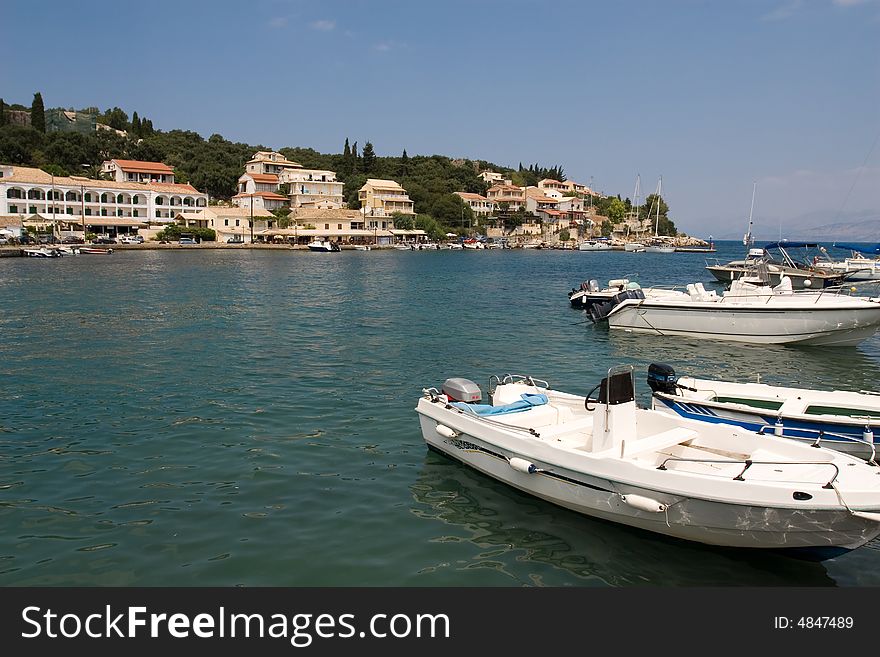 Boats and typical greek house near sea at Kassiopi. Boats and typical greek house near sea at Kassiopi