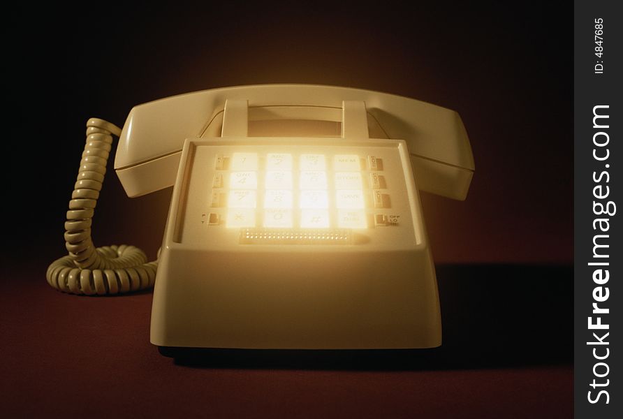 Telephone set close-up with luminous buttons