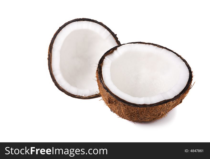 Two halves of a coconut on white background (focus on front piece). Two halves of a coconut on white background (focus on front piece)