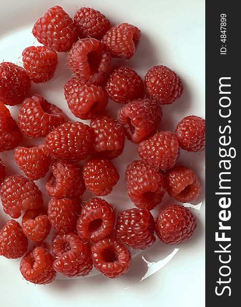 White plate with fresh raspberries. All in focus. White plate with fresh raspberries. All in focus.