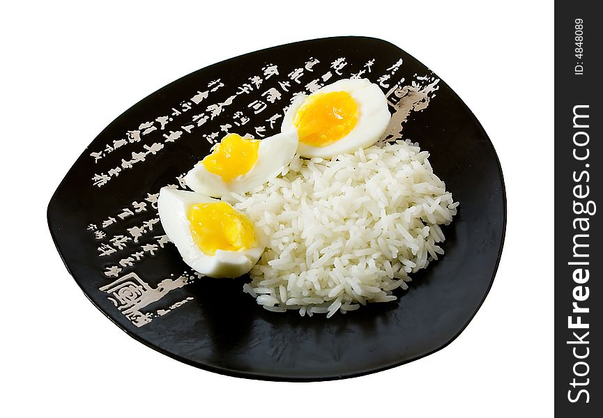 Rice and eggs on the isolated plate with hieroglyphes. Rice and eggs on the isolated plate with hieroglyphes