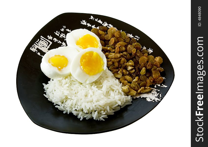 Rice, eggs, nuts and raisin on the isolated plate with hieroglyphes. Rice, eggs, nuts and raisin on the isolated plate with hieroglyphes