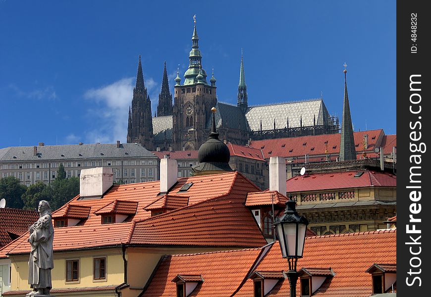 Cathedral of saint Vitus in Prague with tiled roofs in front of