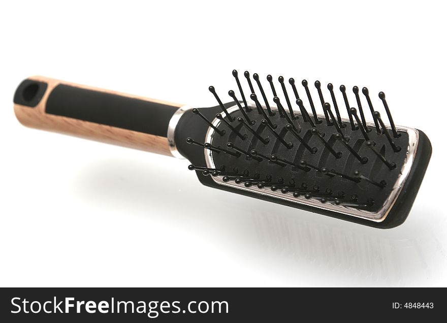 Black hairbrush on a white background