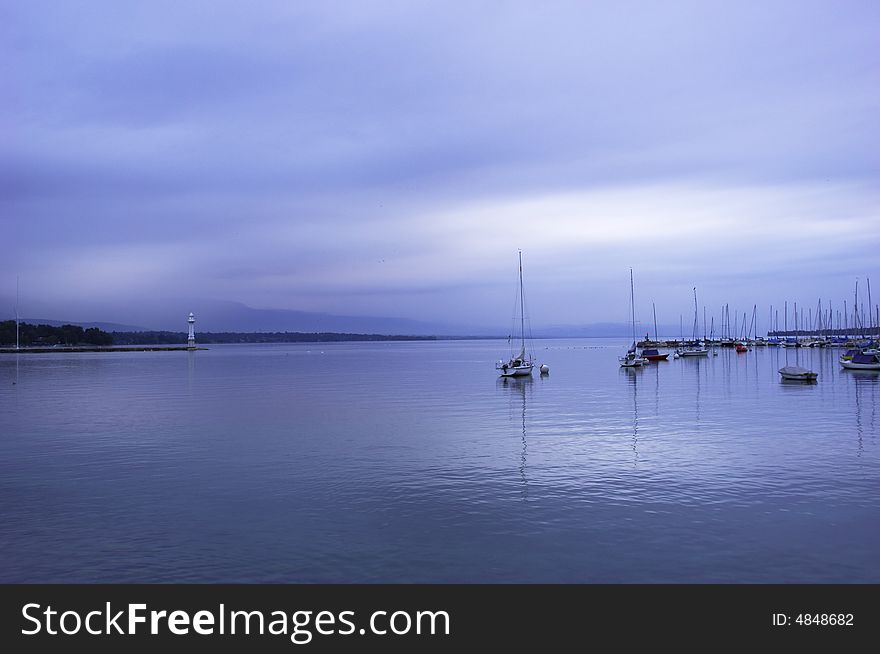 Quiet sailboat lough in the morning, geneva lake, switzerland. Quiet sailboat lough in the morning, geneva lake, switzerland.