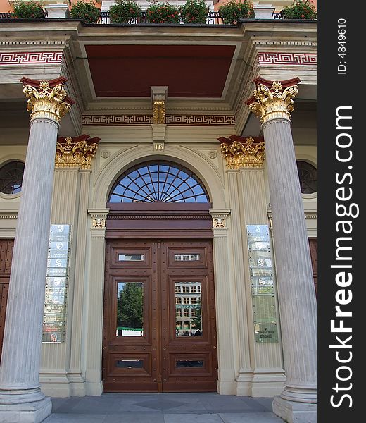 The old wooden door among columns