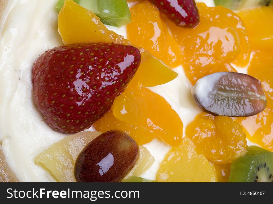 Close-up of fruits on a pie with cream