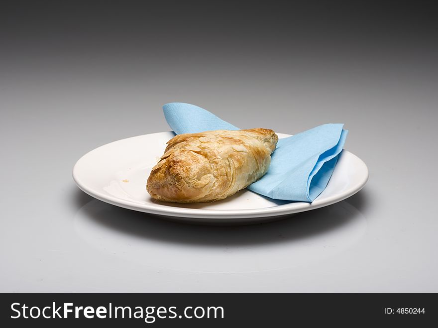 Croissants on a plate with a blue tissue