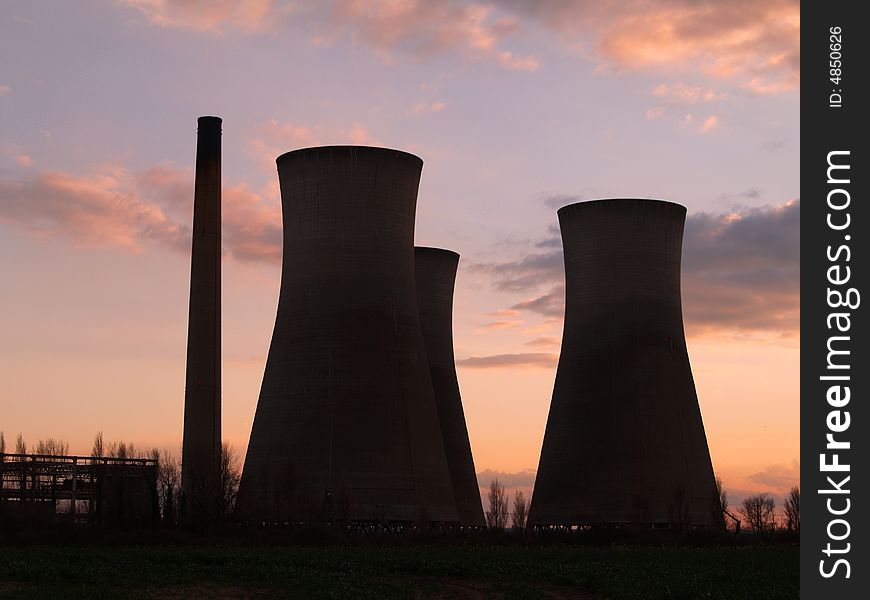 Industrial chimneys in sunset light.