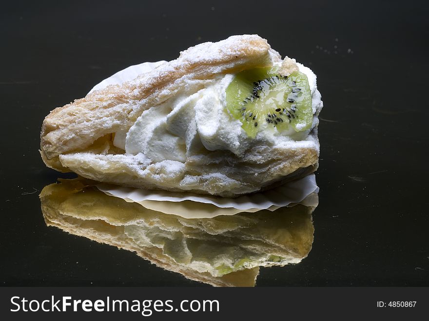 Creamy fruit cakes on a mirror surface. Creamy fruit cakes on a mirror surface