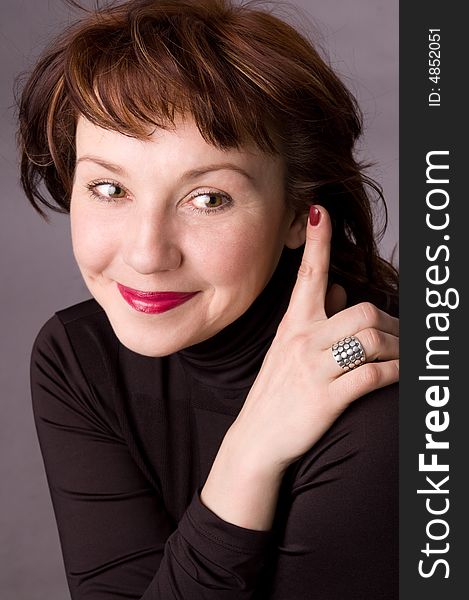 Portrait of the woman in studio on a grey background. Portrait of the woman in studio on a grey background.