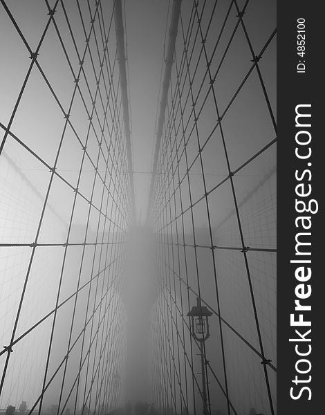 Cables leading to the main tower of the Brooklyn Bridge on a foggy morning.