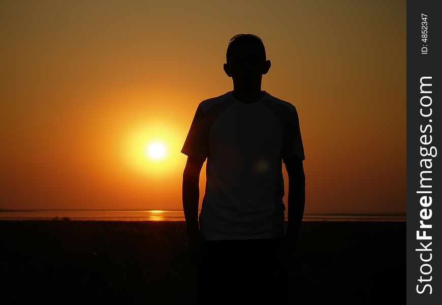 Silhouette of the man on a sunset