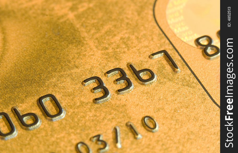 Macro shot of a gold credit card. Macro shot of a gold credit card