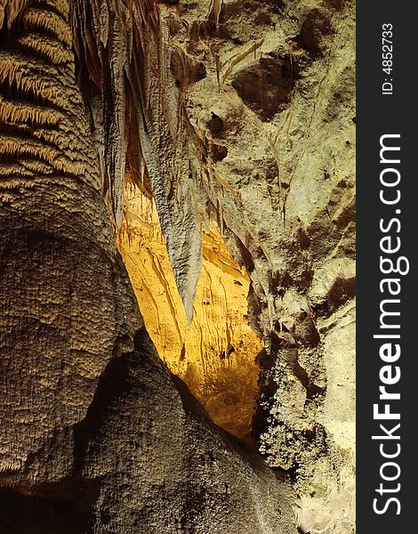 Yellow lit cave in the Big Room of Carlsbad Caverns National Park. Yellow lit cave in the Big Room of Carlsbad Caverns National Park