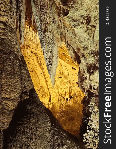 Yellow lit cave in the Big Room of Carlsbad Caverns National Park. Yellow lit cave in the Big Room of Carlsbad Caverns National Park