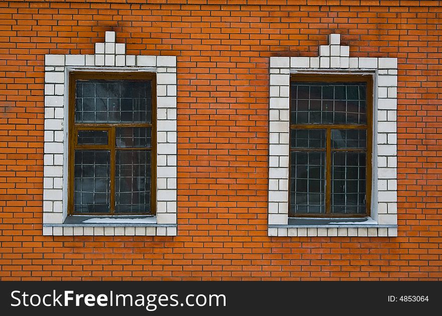 The Red brick wall with bars on windows