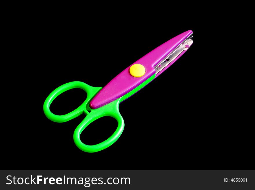 A pair of colored scissors on a black background