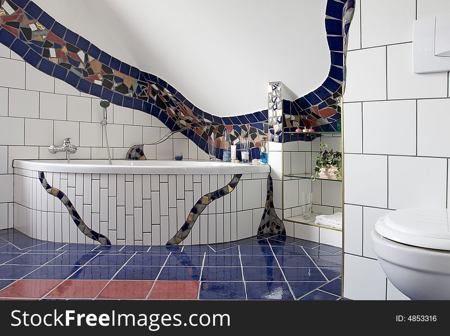 Stylish bathroom with a blue and white mosaic tiles and ornaments