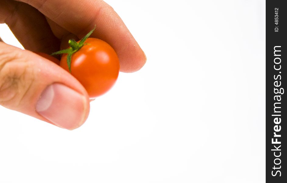 Tomato ingredient being dropped by hand